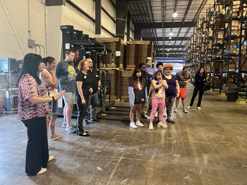 A group of individuals tour a plant as part of Goodwill's Professional Connections program.